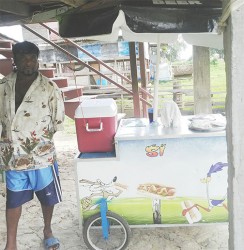 Shameer standing next to his Hotdog cart