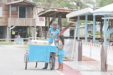 A snow-cone vendor serving a Zeeburg youngster.