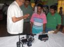 Rudolph King, president of the Tactical Commercial Equipment Sales Inc (left) shows fishermen the wristwatch equipped with GPS. On the table are other pieces of equipment that will be imported by the company.