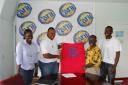 Marketing Manager of Ansa McAl Ltd., Troy Cadogan hands over one of the jerseys to Joseph ‘Bill’ Wilson as Sharon Abrams (Treasurer) and Marlon Wade (manager) of Bakewell Buxton United Football club look on.  (Lawrence Fanfair photo)