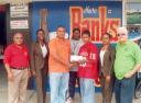 Banks DIH sales Manager (Berbice) Joshua Torrezao presents Neil Reece with his cheque in the presence of other Banks DIH officials including Banks Premium Beer manager Mike Fung.