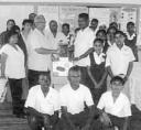 Samsaywack Singh (left) hands over the supplies to Head Teacher at the Saraswat Primary School Esau Dookie in the presence of some teachers and students.