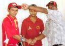 Berbice senior coach Michael Hyles presents Sewnarine Chattergoon with the cap as Albion Cricket Club team manager Ramkumar Doodnauth (centre), looks on.
