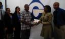 Venita Bovell, CLICO’s Sales and Marketing Manager (second from right) handing over the $100,000 cheque to Terrence Corlette to assist his daughter Tashana in getting medical attention overseas.