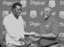 CALL FREE! West Indies cricket captain Chris Gayle, left, receives a quantity of Digicel SIM cards from Donovan White, head of marketing at Digicel Guyana for use by the West Indies players during the Home Series against Sri Lanka which starts on Saturday