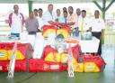 Cricket master of St Stanislaus, College Seivewright Benjamin, collects one of the kits from Marketing Manager Georgetown Cricket Association (GCA) Les Ramalho as other executives and students look on. (Clairmonte Marcus photo).(See story on page 26