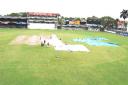 Grounds men at work; their efforts were in vain as the second day was a no play due to rain.