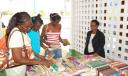 A representative of the Georgetown Reading and Research Centre (right) helping book lovers to choose from the wide selection available at “The Book Feast of 2008”.