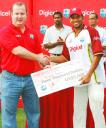 MAN OF THE MOMENT AND THE SERIES! Ramnaresh Sarwan’s rich vein of form blossomed into his 10th test century as he led the West Indies to a series-squaring triumph yesterday against Sri Lanka. Above, Sarwan receives the man of the match prize of US$3000 from Nial Dorian of Digicel Trinidad and Tobago. Sarwan was also the recipient of a cheque for US$6000 for being adjudged the Player of the Series. (Lawrence Fanfair photo)