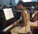A student entertains at one of the annual concerts while Marilyn Dewar (right) looks on.