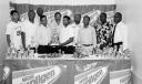 Santos’s Trevorn Lycott receives the championship trophy from Ramdat Rampersaud, Nestle brand manager, in the presence of other prize winners and executives of the Georgetown Football Association. (Clairmonte Marcus Photo).