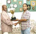Mayor Hamilton Green presents the Mayor’s Cup Trophy to Alpha United captain Leon Grumble in  his office,at City Hall.