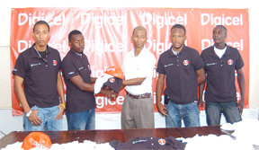 Digicel Marketing Officer Shirwin Campbell hands over one of the polo t-shirts to captain of Alpha United Leon Grumble while teammates Gordon Henry, Kelvin McKenzie and Andrew Murray sport theirs. (Aubrey Crawford photo)