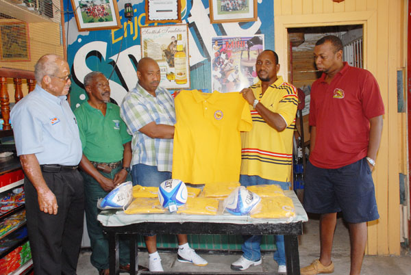 President of the Guyana Rugby Referees Society, Conrad Arjoon, second from right and Baxter Dennis displays one of the Polo jerseys. Others in picture are from left, Michael Carrega, Terrence Grant and Alton Agard.