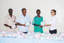 Coach of the Guyana Defence Force football team, Calvin Allen, receives one of the footballs from Michelle Brancker, Public Relations Manager of Food for the Poor as Director of Sport Neil Kumar and Inspector Colin Boyce look on admiringly. (Lawrence Fanfair photo)