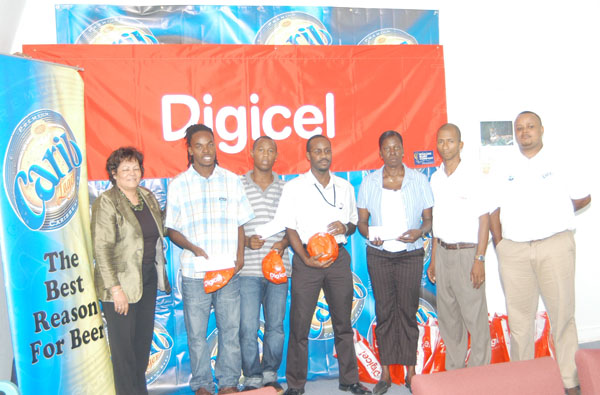 Managing Director of Ansa McAl Trading Limited,  Beverly Harper (extreme left) along with Marketing Manager, Ansa McAl Troy Cadogan (extreme right), Digicel Marketing Officer Shirwin Campbell (second right) and tournament organizer Sharon Abrams, stand with representatives of the teams who were awarded prizes won in the just-concluded Sweet 16 football tournament. (Aubrey Crawford photo)