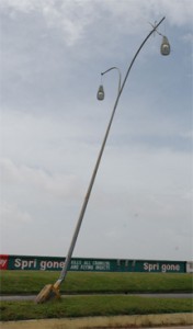 Hanging in there: Though tilted and practically uprooted this streetlight on the Rupert Craig highway around the Bel Air Gardens area is still standing. (Photo by Jules Gibson)