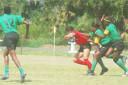 Two Jamaican defenders are about to tackle this Trinidadian forward during their first round clash in the Demlife/Tropical Rhythm sponsored North American West Indies Rugby Association (NAWIRA)/Guyana Rugby Football Union (GRFU) Women’s 15-a-side competition at the National Park yesterday. (Lawrence Fanfair photo)
