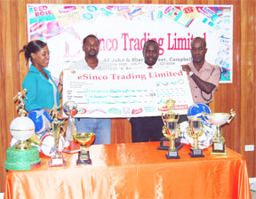 Nathely Mars Personnel Manager DeSinco Trading Limited (extreme left) hands over the cheque to second vice- president of the Georgetown Football Association (GFA) Captain Tyrone Smith (extreme right) whilst secretary of the GFA Marlon Cole (2nd right) and first vice-president GFA Wayne Forde (2nd left) look on. (A Lawrence Fanfair photo)