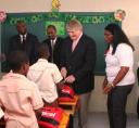 Digicel Group Chairman Denis O’Brien, second from right, engages a few Ecole St Patrick primary school students at the opening of a school that the Digicel Haiti Foundation built.