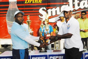 Orin Forde, left, receives his man-of-the match award from Chairman of the  Competitions Committee of the Guyana Cricket Board, Colin Europe. (Lawrence Fanfair photo)