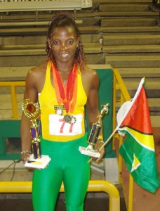 Alisha Fortune exhibits a few of the trophies that she won during the Hampton International Games last weekend at the Hasley Crawford Stadium in Trinidad. (Kiev Chesney photo)