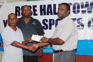 Guyana Telephone and Telegraph (GT&T) Company Marketing Director Wyston Robertson (right) hands over the cheque to Organizing Secretary of Rose Hall Town Youth and Sports Club Ravindranauth Kissoonlall. At centre is RHTYSC Secretary Hilbert Foster. (A Clairmonte Marcus photo)