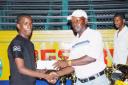 Nigel Bryan, left, receives a cheque from treasurer of the Guyana Table Tennis Association, Joel Wilburg, for his exploits during the Caribbean TT championships.