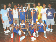 The 2008 Inter-Organisation’s champions Neal and Massy Group of Companies basketball team pose for this Clairmonte Marcus photograph with their medals and trophy along with the team’s coach and the tournament organizers.  