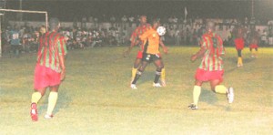 Sunburst Camptown Telson Mc Kinnon controls the ball on his chest whilst being closely marked by Devon Harris during their intense battle in the Sweet 16 final at the Plaisance ground on Monday. Keith Blackman (left) and Shawn Authur (right) rushes in to offer assistance to Harris. (Lawrence Fanfair photo)