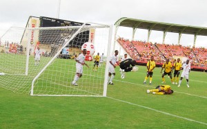 Truly Number One!’ is probably what is going through the minds of the Suriname players after their custodian Ronny Aloema (number 1) effected a save following a header form Guyana’s Gregory ‘Jackie Chan’ Richardson (9 on ground). (Lawrence Fanfair photograph)