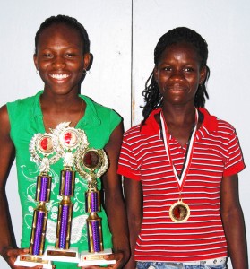 Coached from scratch: Alika Morgan (left) and Janelle Jonas (right), the country’s top locally-based female runners, both of whom have been coached from scratch by Leslie Black were captured with their spoils from the 2008 Hampton Games. 