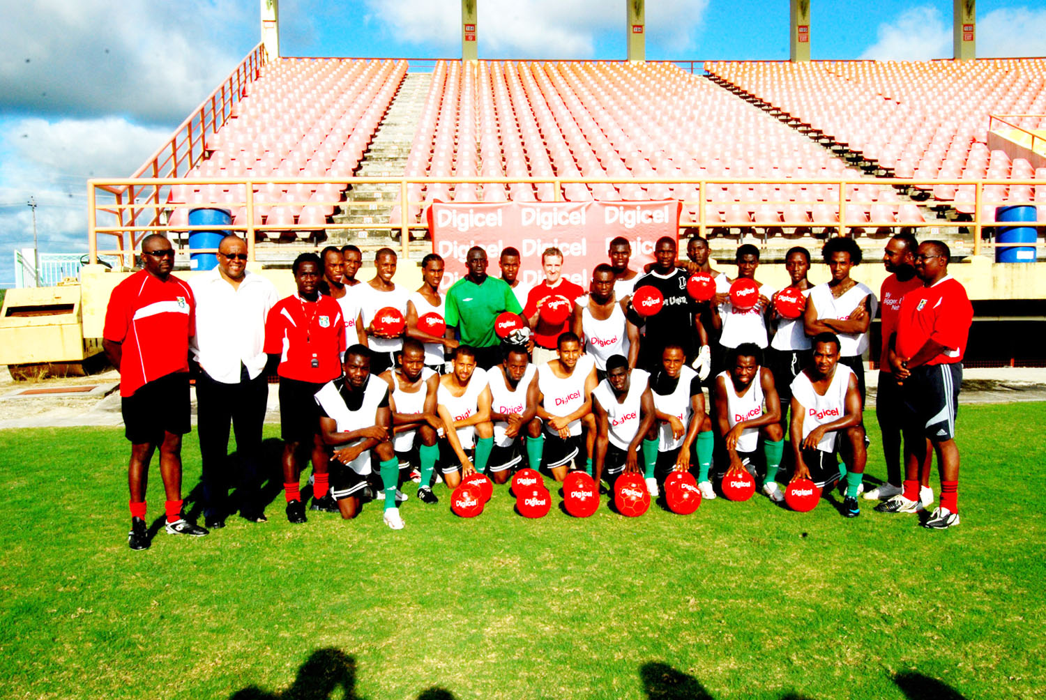 Members of the Golden Jaguars took time out for this photo opportunity with chief executive Officer of Digicel Guyana Limited Mark Linehan (10th from right) at the National Stadium, Providence yesterday. At extreme right back row is Technical director of the team Jamaal Shabazz. (Lawrence Fanfair photo)