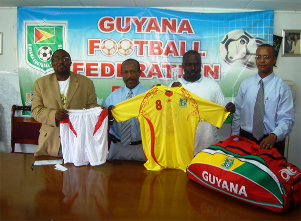 From left Technical director of the Guyana Football Federation (GFF) Jamaal Shabazz, president of the GFF Colin Klass along with Garth Nelson and Aubrey Hudson display one of the new uniforms. 