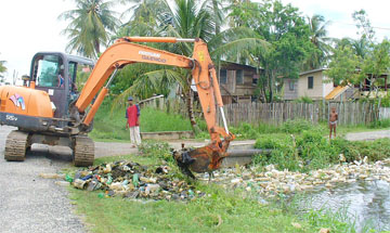  An excavator from the MMA/ADA clearing garbage from a drain at Bennette Dam, D’ Edward Village.