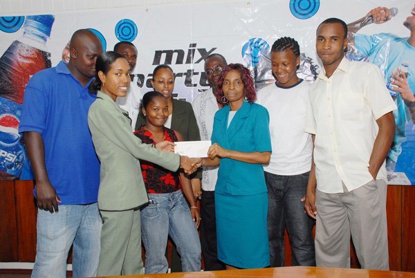 Vice President of Pepsi Sonics Basketball Club Linda Whyte (front right), accompanied by other executive members and players, receives a cheque valued at some  $400,000 from Marketing Assistant of Demerara Distillers Ltd Alana Johnson (front left) yesterday at DDL’s Kingston Office
