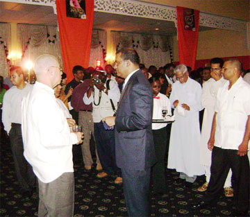 President Bharrat Jagdeo (centre) speaking with retired Major General Norman McLean (left) and other persons during the launch of the Guyana Times at Le Meridien Pegasus last night. 