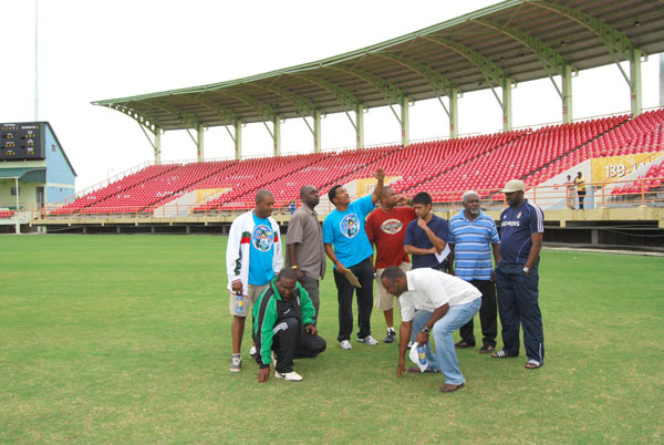 Technical Director of the Guyana Football Federa-tion (GFF) Jamaal Shabbazz, stooping left, inspects the ground at the Providence National Stadium ahead of Guyana’s return 2010 World Cup qualifying fixture against Suriname this Sunday. Others in picture are from left,  David Christopher, Aubrey `Shanghai’ Major, Kashif Muhammad,  Andrew Sue Kam Ling,  Faizal Khan, Winston Callender, Kavin Pearce and Frank `English’ Parris stooping right. (Lawrence Fanfair photo)