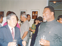 Arthur Chung (left) sharing a light moment with Prime Minister Sam Hinds at a Canada Day reception in July 1999. (Stabroek News file photo)