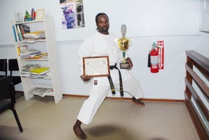 Troy Bobb shows off the trophy and plaque he won after gaining his fifth title at the United States Karate Alliance National Championships March 27-30 in Albuquerque, Mexico.