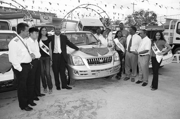 is Prime Minister Samuel Hinds (third from right) and CEO of National Hardware Eddie Boyer (second from right) and others inspecting the new JAC vehicles. (GINA photo)      
