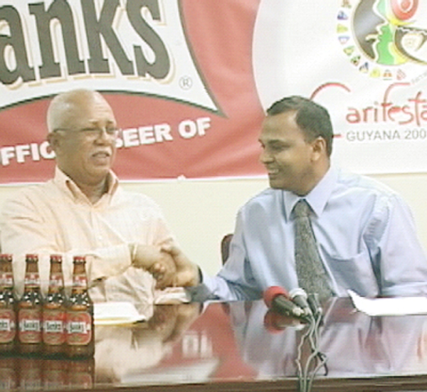 Banks DIH Chairman Clifford Reis (left) and Minister of Culture, Frank Anthony sealing the deal (GINA photo)