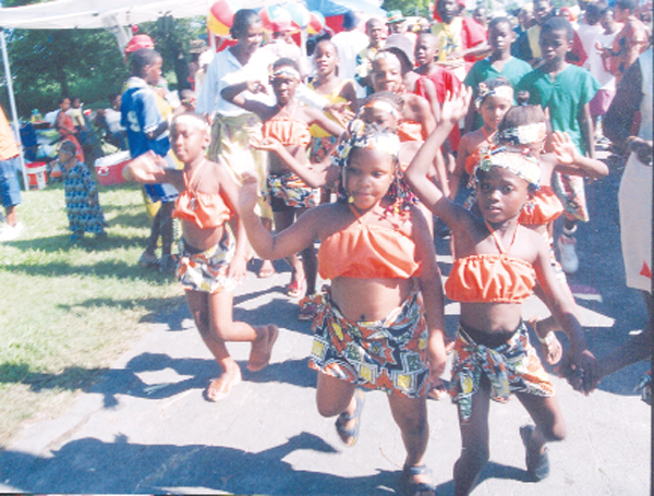 Little misses dance their way into the National Park on Emancipation Day 2005. (Stabroek News file photo) 