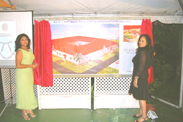 Sensei Maureen Woon-A-Tai, wife of Frank Woon-A-Tai (right) and Patron of the Guyana Karate College Varshnie Singh unveil the architectural plans of the Guyana Karate College (GKC) at the 40th anniversary fund-raising dinner last Thursday night. (Lawrence Fanfair photo)