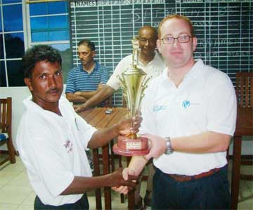 WAY TO GO MIKE! Mike Mangal (left) receives the Neal and Massy 40th anniversary trophy from Brand Manager Stuart May. 