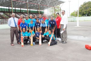 NSC  chairman Neil Kumar (right) pose with T&T manager Joyce Ishmael (next to him) and the Trinidad school girls wind ball team.