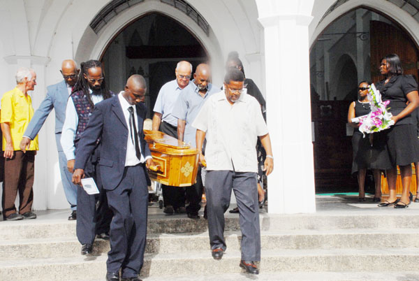 Pall bearers carry the casket of John Nestor out of the Cathedral of the Immaculate Conception, Brickdam yesterday. (Clairmonte Marcus photo)