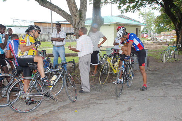 National cycling coach Hassan Mohammed, M.S explains the art of cycling to some riders at the National Park yesterday.