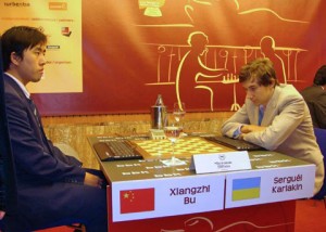 When the blindfolds are removed, players type in their moves on the computer keyboards. Tournament winner Bu, and Karjakin are obviously thinking about their moves and which ones to play on the chessboard. 