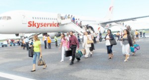 Passengers disembark the Sky Services inaugural flight minutes after it touched down at Timehri.  